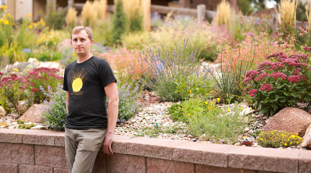 Man standing in front of garden bed