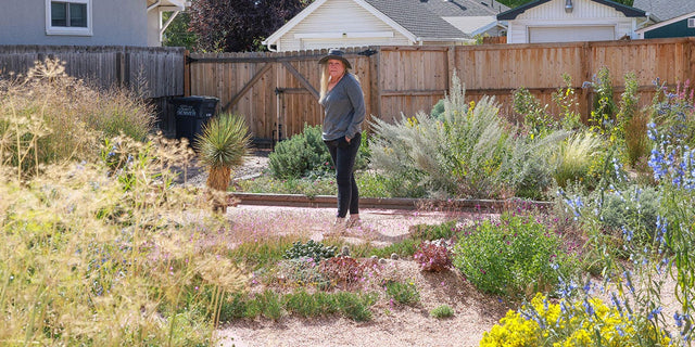 Find the right plants for a thriving drought-tolerant garden. Heidi, a High Country Gardens customer, stands in her Denver xeriscape garden.